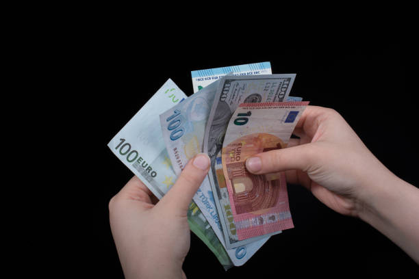 istock Hand holding American dollar  isolated on black background 972781942