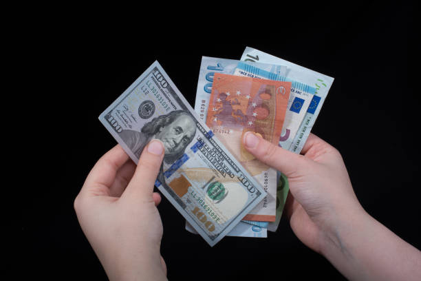 istock Hand holding American dollar  isolated on black background 972781964