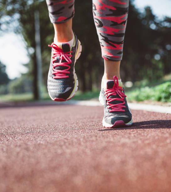 istock Unrecognizable woman running on a track 972785532