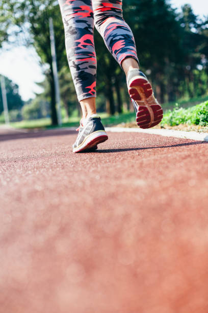 istock Unrecognizable woman running on a track 972787874