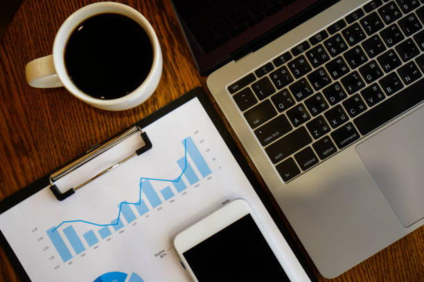 istock business documents on office table with smart phone and digital tablet and graph financial with social network diagram and computer laptop on wood desk 972788046