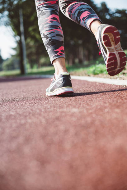 istock Unrecognizable woman running on a track 972791178