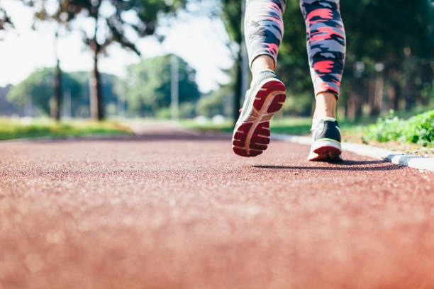 istock Unrecognizable woman running on a track 972792074