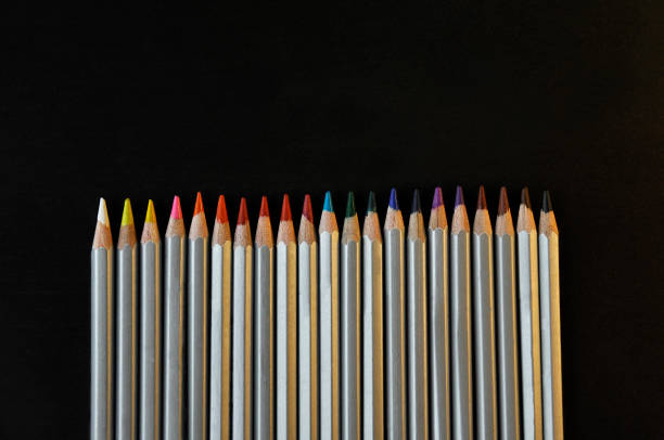 istock Colourful rainbow pencils for drawing on the black background 972792118