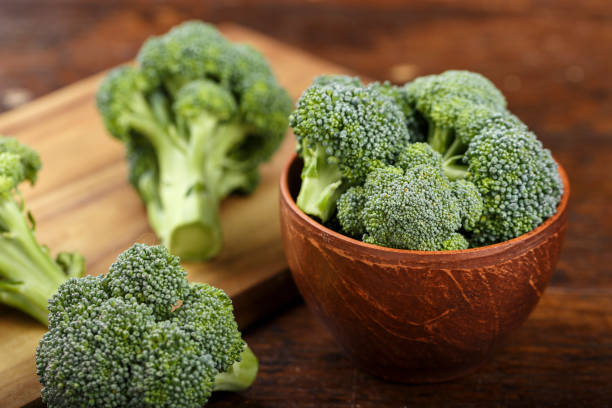 istock raw cabbage broccoli on a wooden table, place for text. 972795068