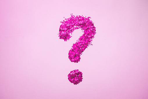 Question mark with glitter on colored background. Minimalism, horizontal