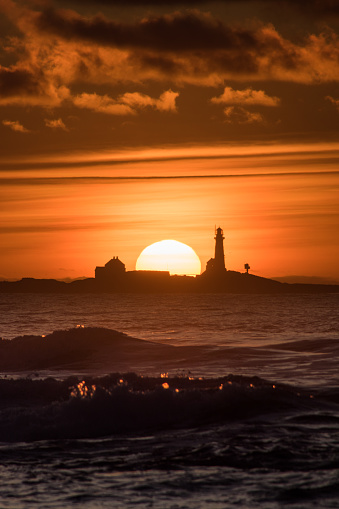 Sunset Hellstø beach with lighthouse yellow red Norway 5