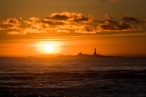 Sunset Hellstø beach with lighthouse yellow red Norway 7