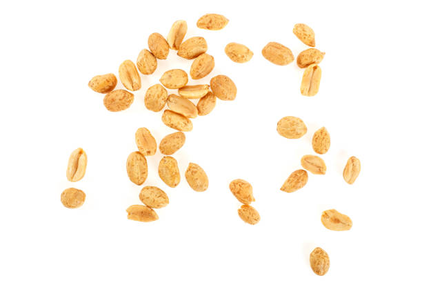 istock Peeled salted peanuts isolated on white background 972836216