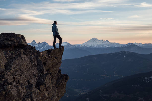istock Man on top of a Cliff 972838778