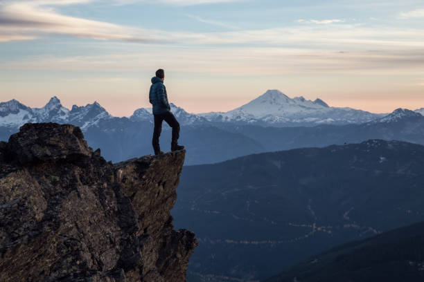 istock Man on top of a Cliff 972838808
