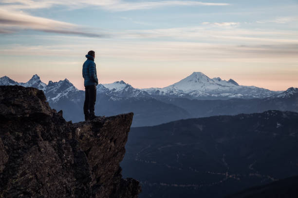 istock Adventurous Man on top of Mountain 972838934