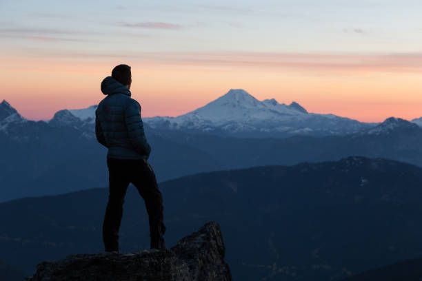 istock Adventurous Man on top of Mountain 972839040
