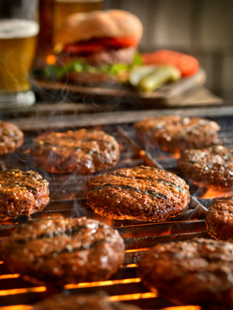 istock Hamburgers on the BBQ with Beers 972839828