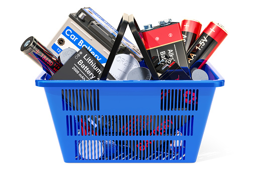 Shopping basket with different batteries. 3D rendering isolated on white background