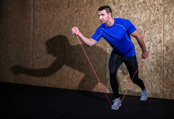 istock Young man uses rope to stretch 972842214