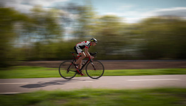 istock Cyclist rides on bicycle, speed effect, side view 972842948