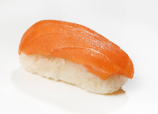 istock Nigiri-sushi with salmon, close-up, white background 972846070