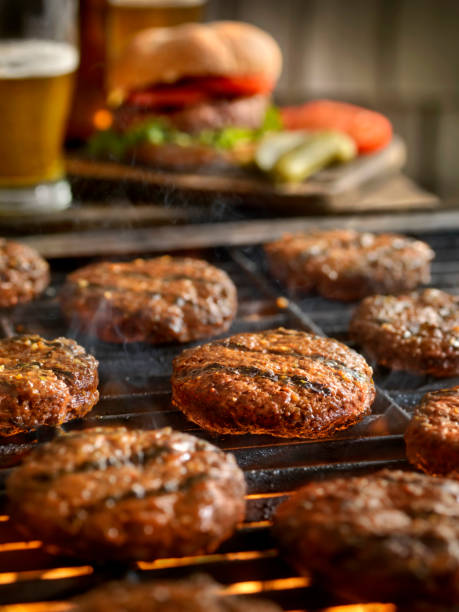istock Hamburgers on the BBQ with Beers 972848402