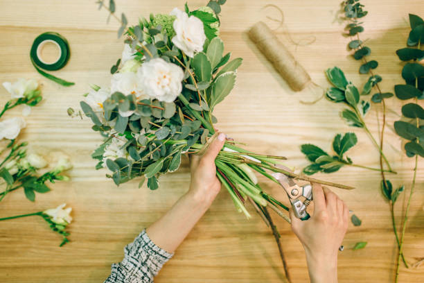 istock Florist hands cuts flower composition with pruner 972849078