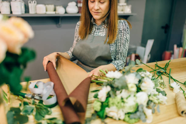 istock Florist hands cuts flower composition with pruner 972849110