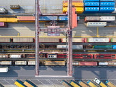 Cargo trains, trucks and a huge crane at freight terminal, Austria