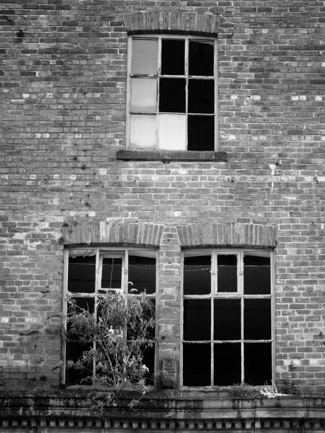 istock broken windows in a derelict abandoned brick building 972862330