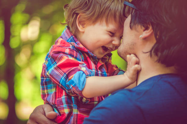 A Nice father and child Playing on great field at Sunset