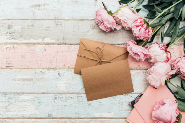 istock craft envelope and greeting card with peony on wooden background 972885494