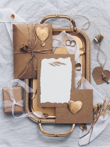 istock Wedding card invitation with decorations on gold tray. top view, flat lay 972888294