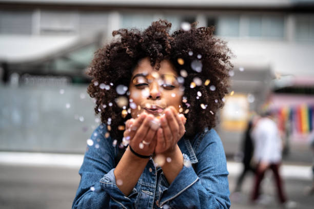 Portrait of cute woman blowing confetti In the so grateful hippie photos stock pictures, royalty-free photos & images