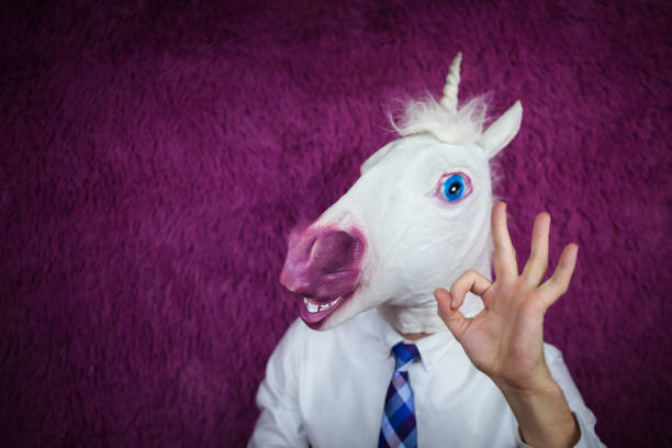istock Freaky young man in comical mask stands on the purple background 972911674