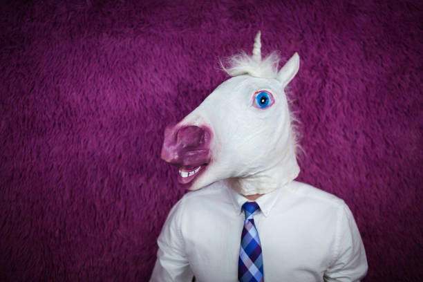 istock Freaky young man in comical mask stands on the purple background 972911712