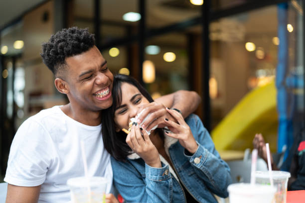 istock Group of young people having fun in a restaurant 972911838