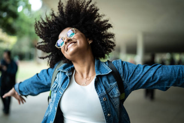 portrait of woman smiling with colorful background - arms outstretched imagens e fotografias de stock