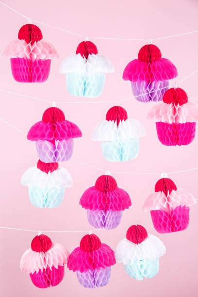 istock Paper cupcakes celebration decoration. Holiday party concept 972916260