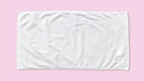 White beach towel mock up isolated with clipping path on pink background, flat lay top view