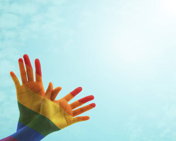 istock Zero discrimination day concept with rainbow flag pattern on people's hand in butterfly shape 972918764