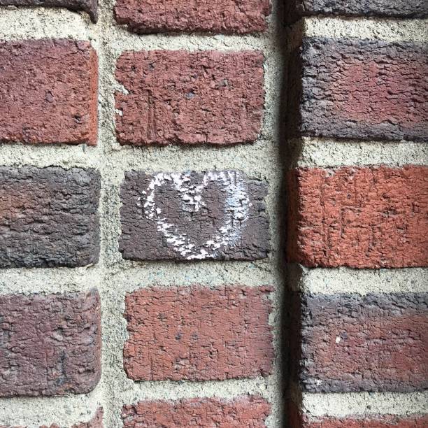 istock Chalk Heart on a brick wall 972919430