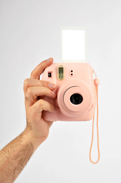 istock Male hand holding instant camera 972937008