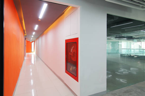 istock Emergency exit of the building with fire exit sign,fire alarm and Fire extinguisher 972937058