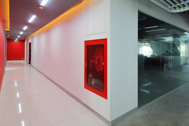 istock Emergency exit of the building with fire exit sign,fire alarm and Fire extinguisher 972937062