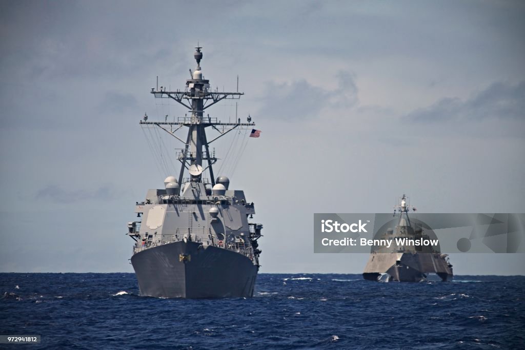 HUNTER KILLER A USS Destroyer and Littoral Combat Ship hunt together in the South Pacific. Taken during a Pacific Deployment in 2014. US Navy Stock Photo