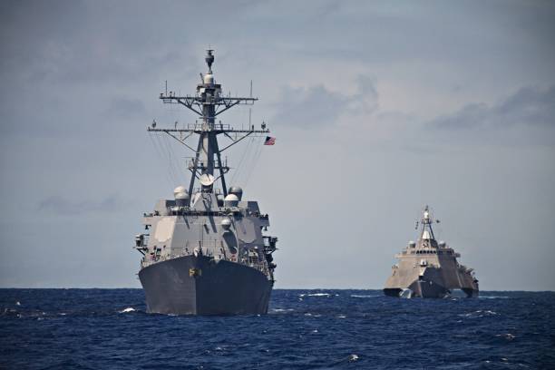 HUNTER KILLER A USS Destroyer and Littoral Combat Ship hunt together in the South Pacific. Taken during a Pacific Deployment in 2014. us navy photos stock pictures, royalty-free photos & images