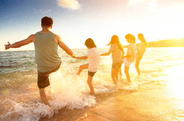 istock happy family having fun on the beach 972961866