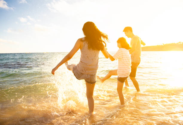 istock happy family having fun on the beach 972961936