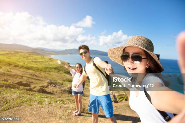 Happy Family Taking Selfie On The Coast Stock Photo - Download Image Now - Family, Travel, Asian and Indian Ethnicities