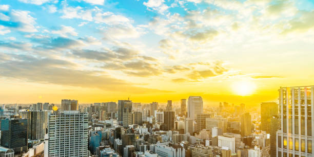 夕暮れの空と東京で黄金の太陽の下でパノラマ都市のスカイライン空撮 - 日の出 ストックフォトと画像