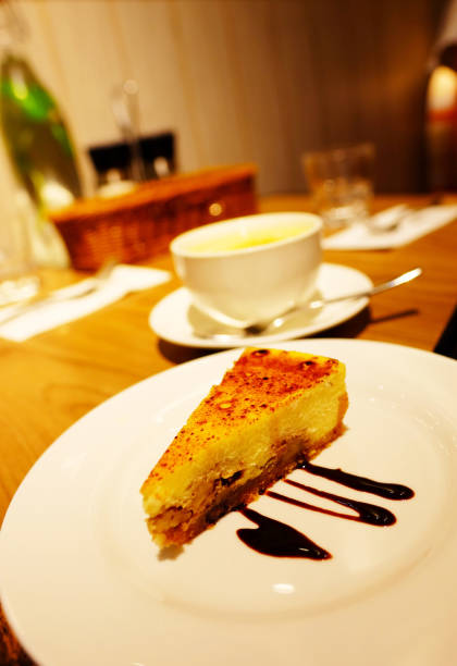 istock Caramel walnut cheese cake with chocolate spread with a cup of drink on the table 972965068