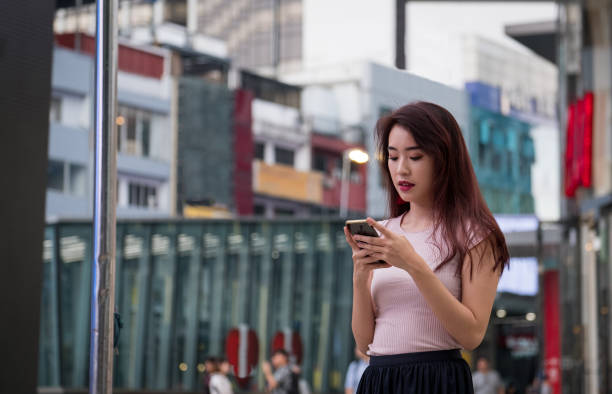 istock Asian girl using her mobile phone 972990868